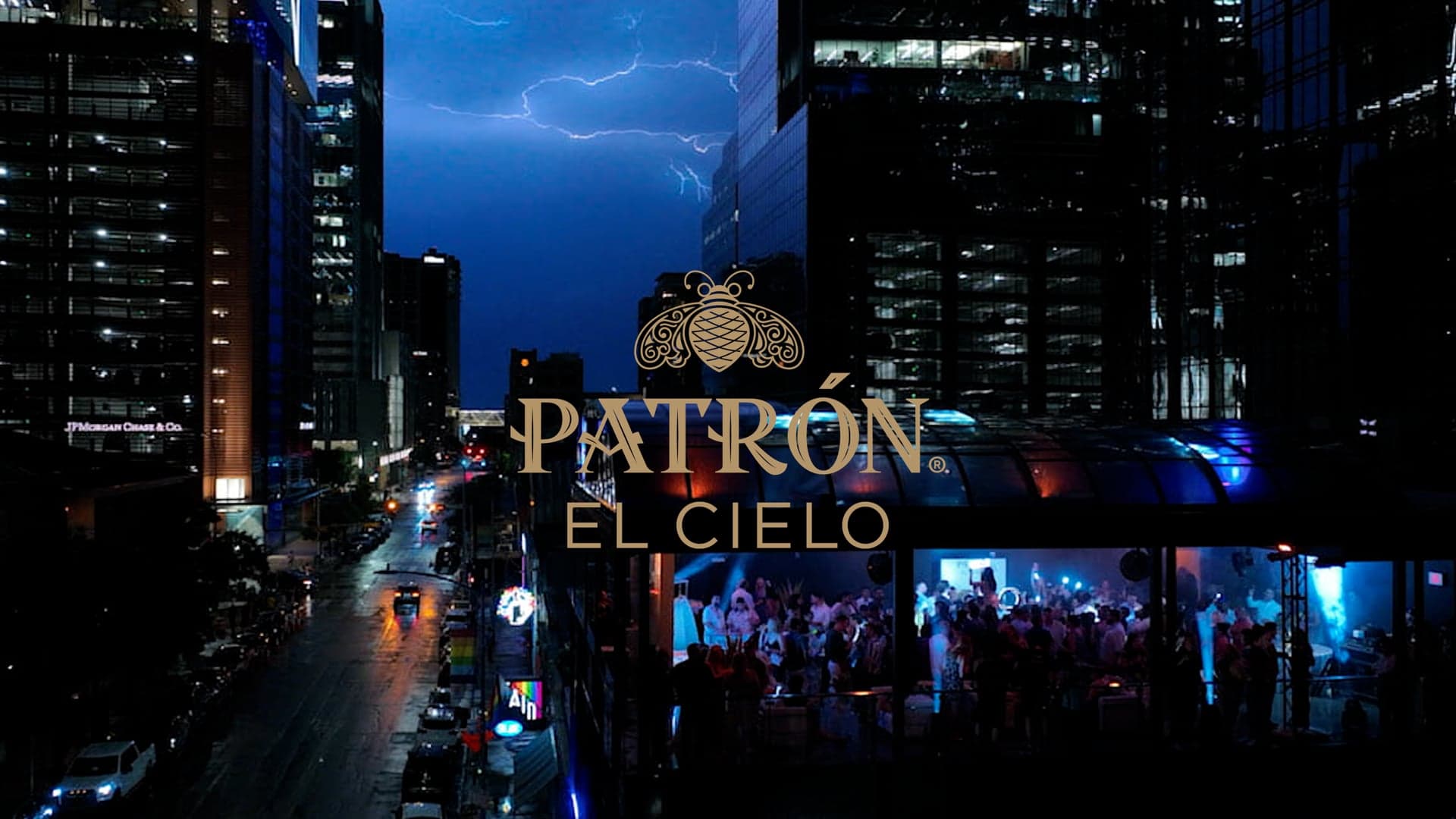 Patron El Cielo launch film poster: gold bee mark and PATRON EL CIELO type over an Austin night rooftop crowd, wet city street, and lightning