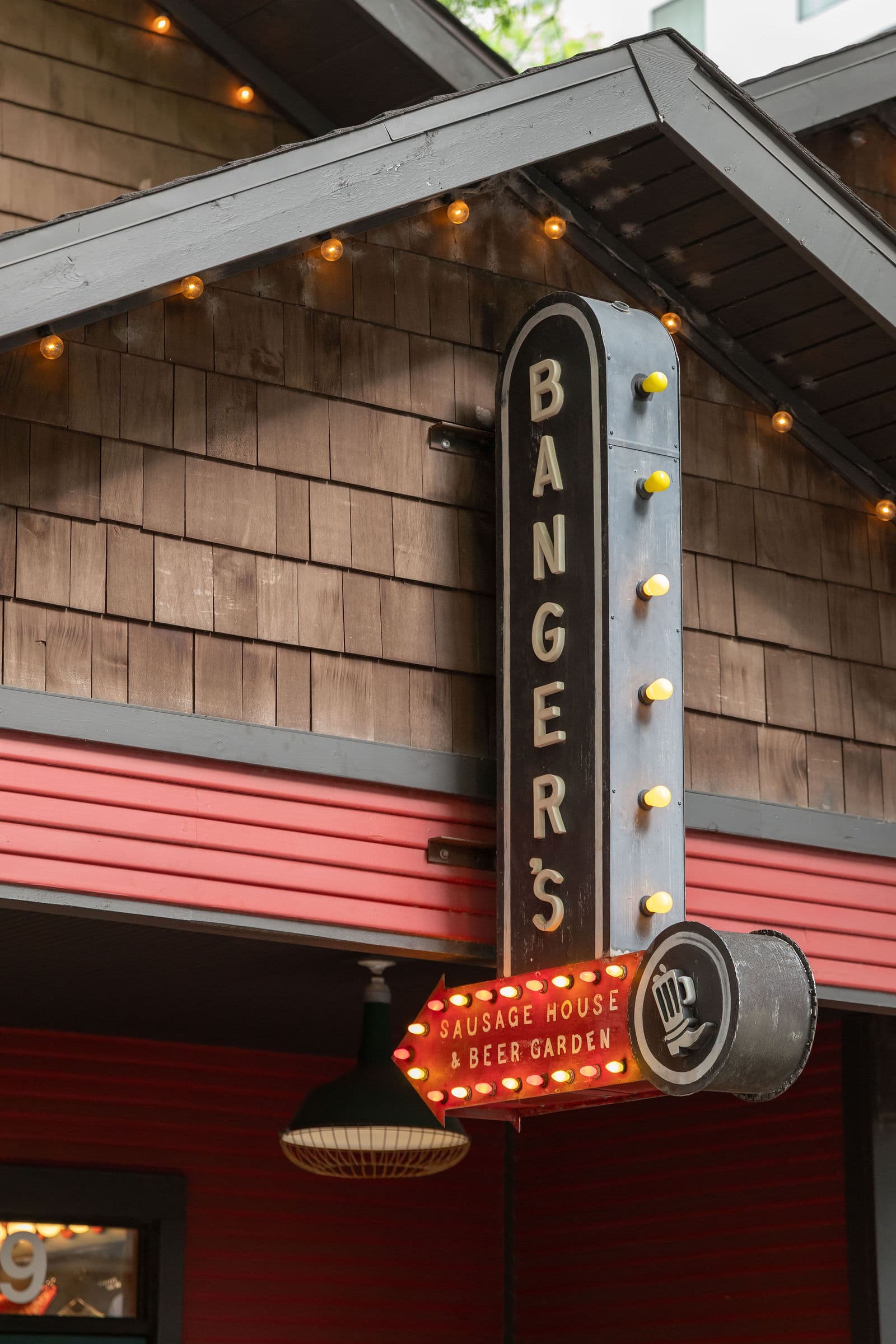 Vintage Banger's Sausage House and Beer Garden marquee on a shingled Austin building, still from the World Wide Partners 2026 set