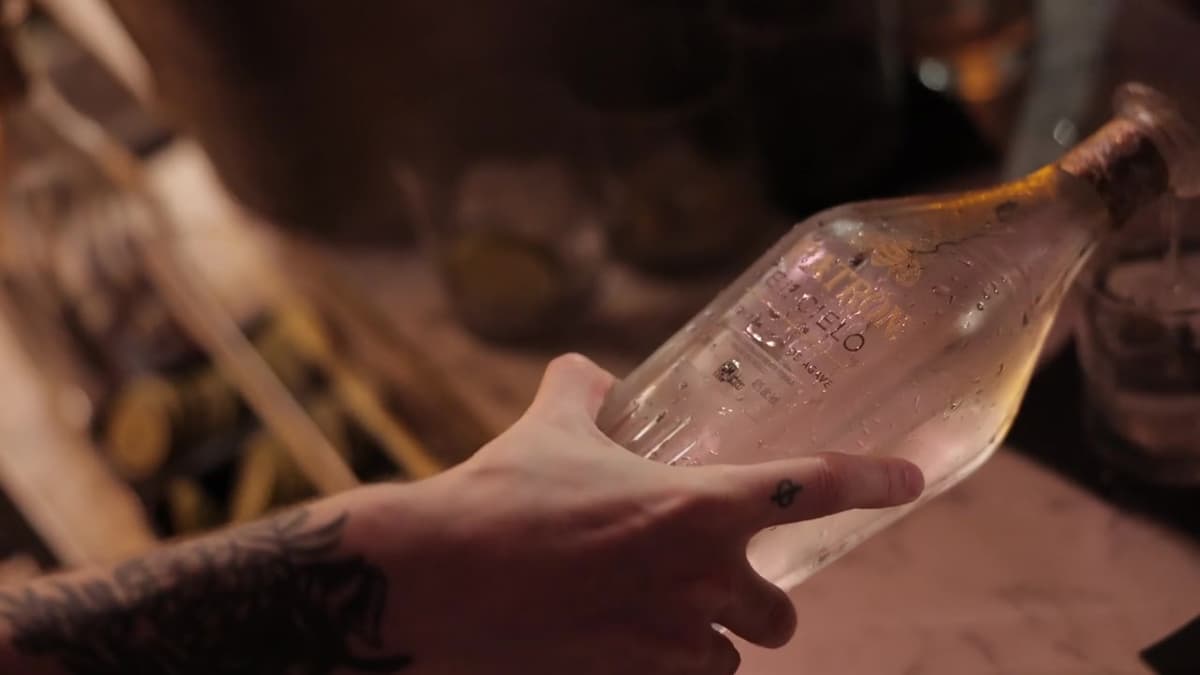 Patron El Cielo Austin film still. A hand pours from a condensation-covered El Cielo bottle.
