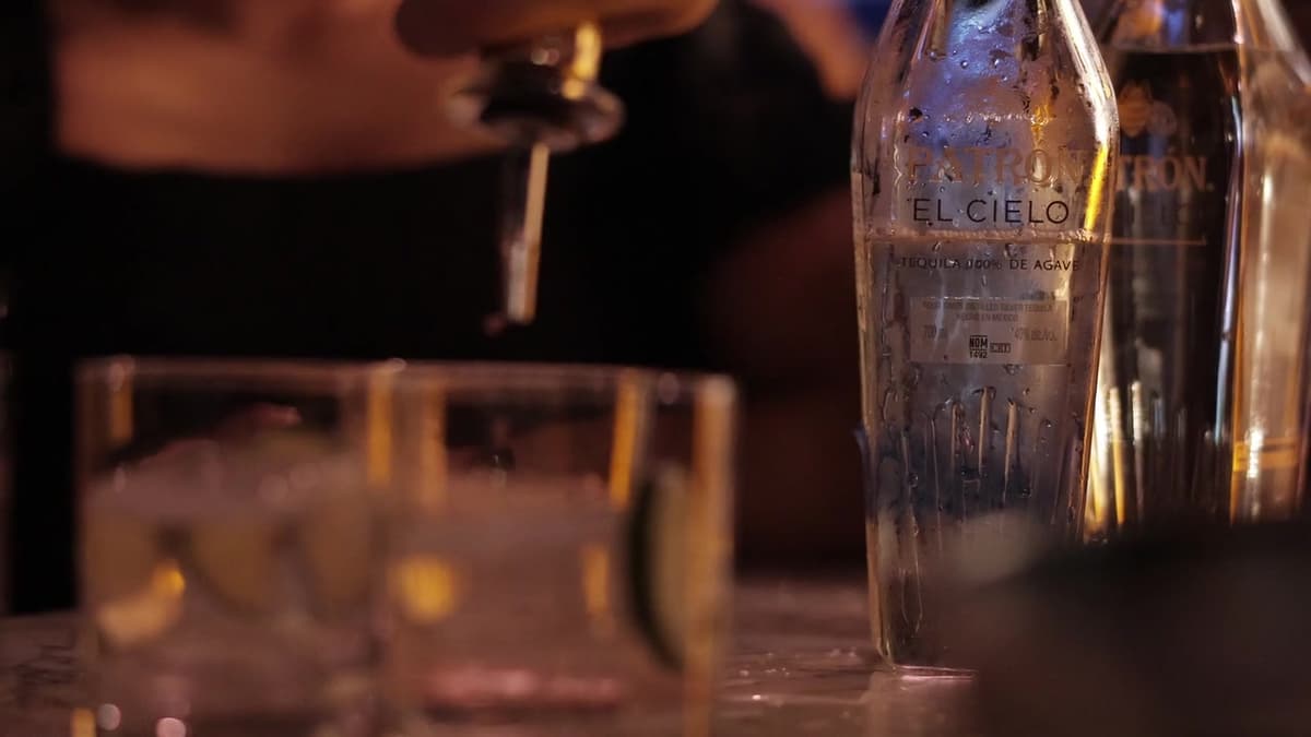 Patron El Cielo Austin film still. El Cielo bottle beside rocks glasses with ice and lime.