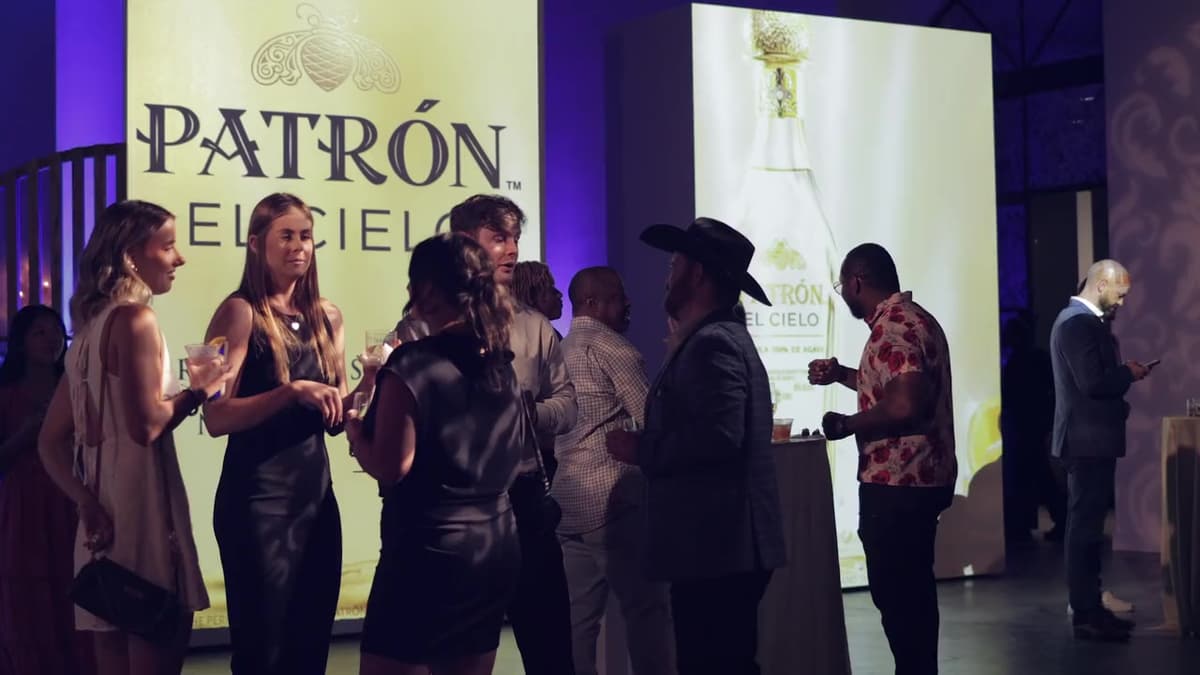 Patron El Cielo Houston film still. Yellow El Cielo wall and a life-size bottle panel.