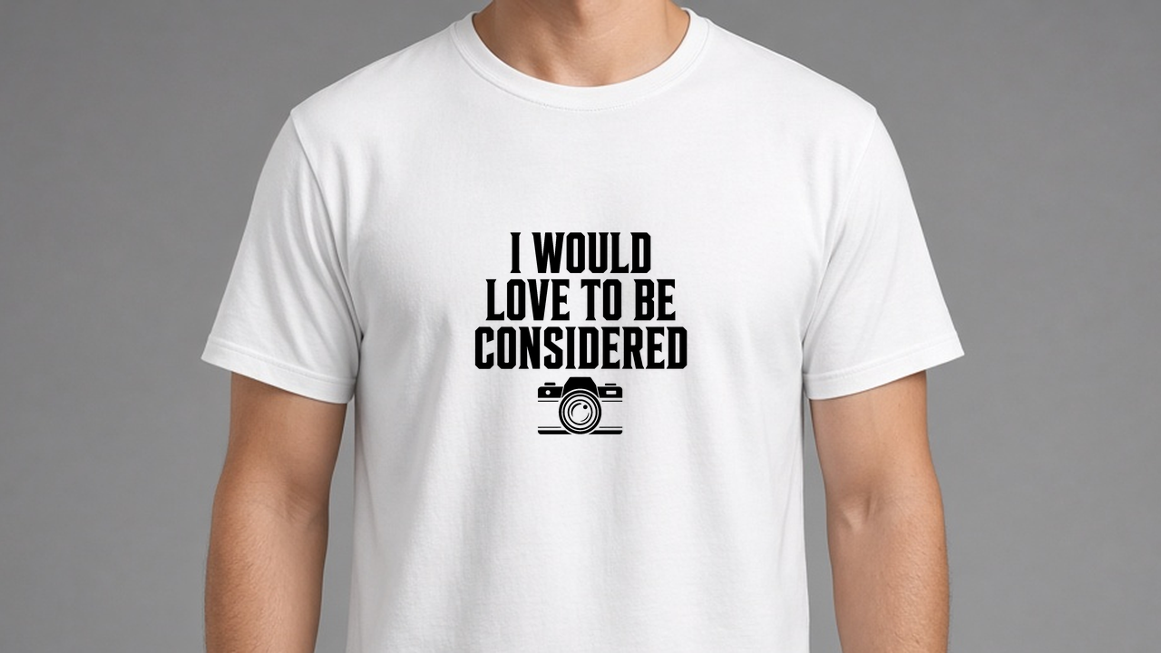 White I Would Love To Be Considered tee, black print on the chest.